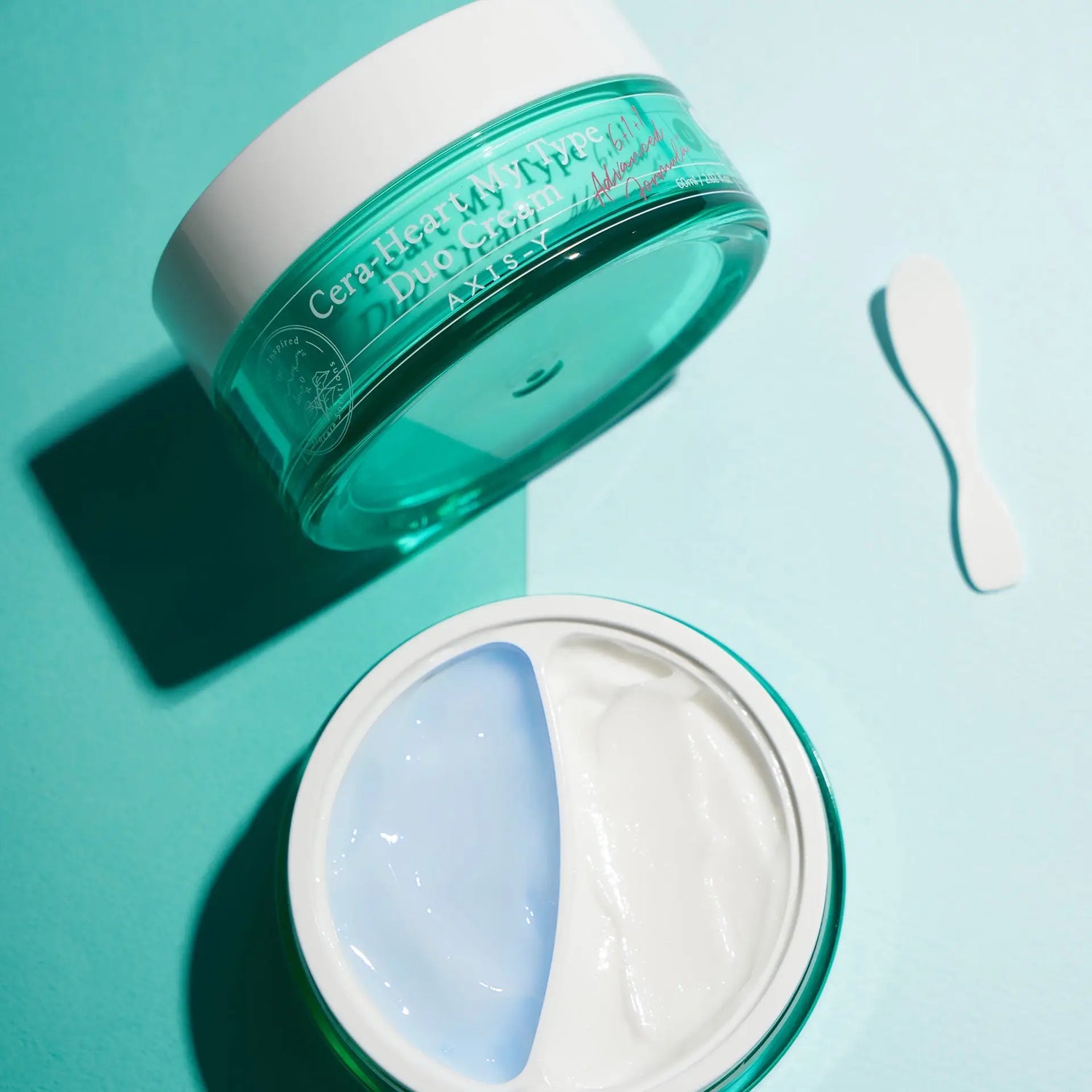 Two-part turquoise face cream from AXIS-Y Skincare for diverse skin types.